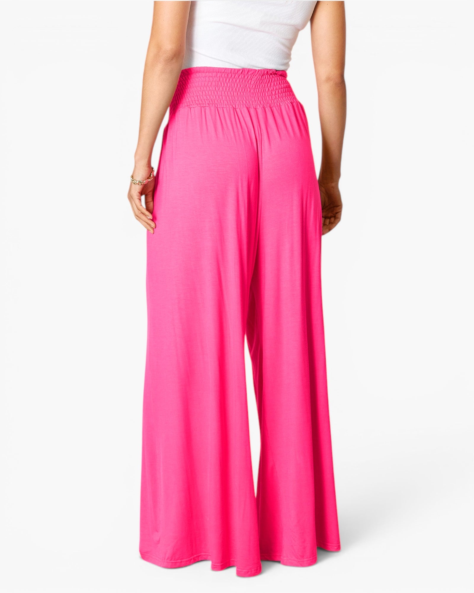 Bright pink wide-leg pants with an elastic waistband, shown on a model from the back against a clean white background.