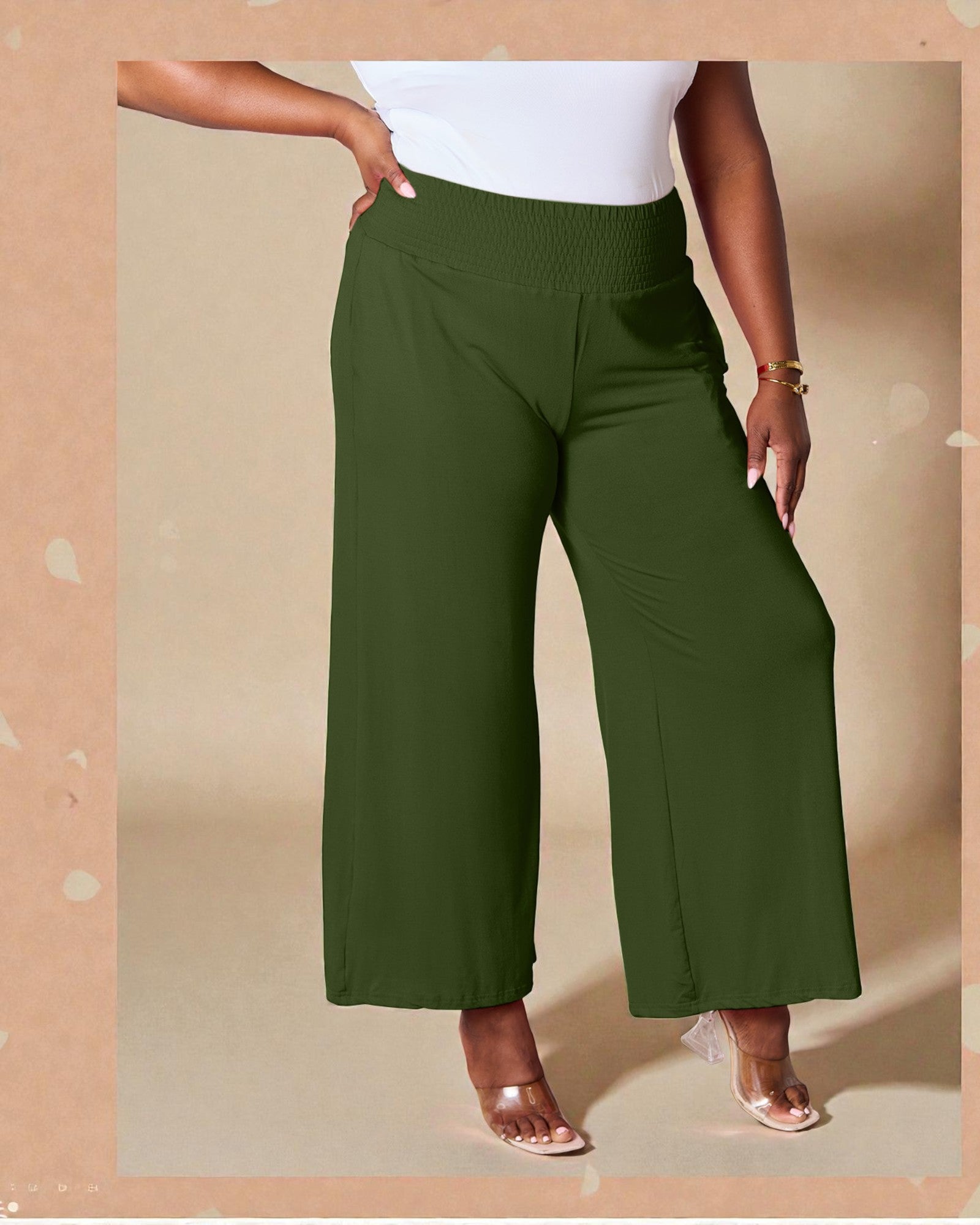 Person wearing green wide-leg pants on a beige background
