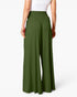 A model shown from the back wearing high-waisted, wide-leg pants in olive green, paired with a white top, against a clean white studio background.