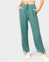Teal pants worn by a person on a white background