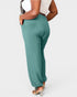 Teal pants worn by a person on a white background