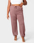 Mauve jogger pants worn by a person on a white background