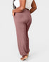 Person wearing mauve pants on a white background