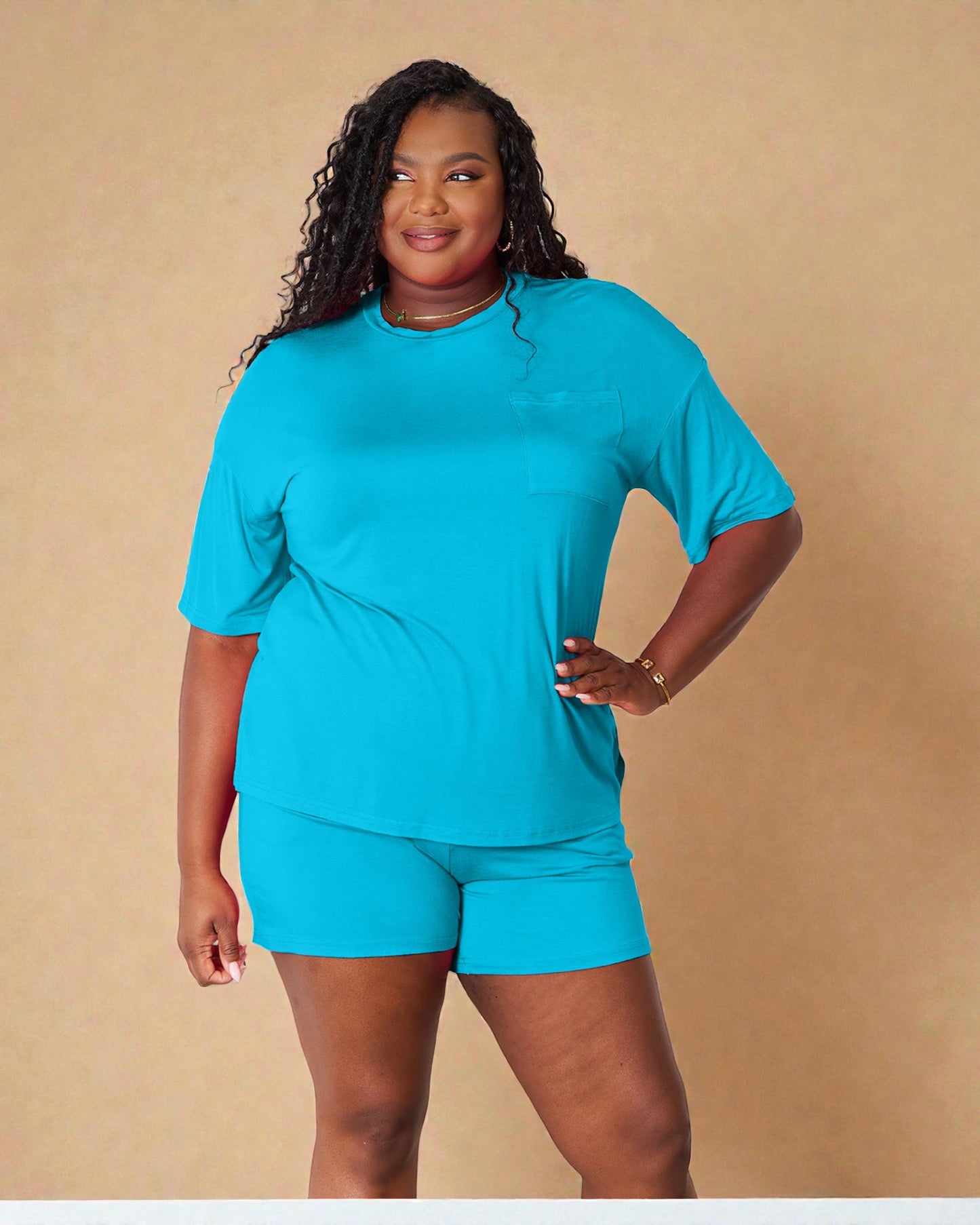 Woman wearing a blue outfit against a beige background