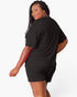 A woman modeling a black short-sleeve t-shirt and matching black shorts against a clean white background.