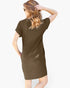 A woman shown from the back wearing a short-sleeve olive brown mini dress against a light gray background.