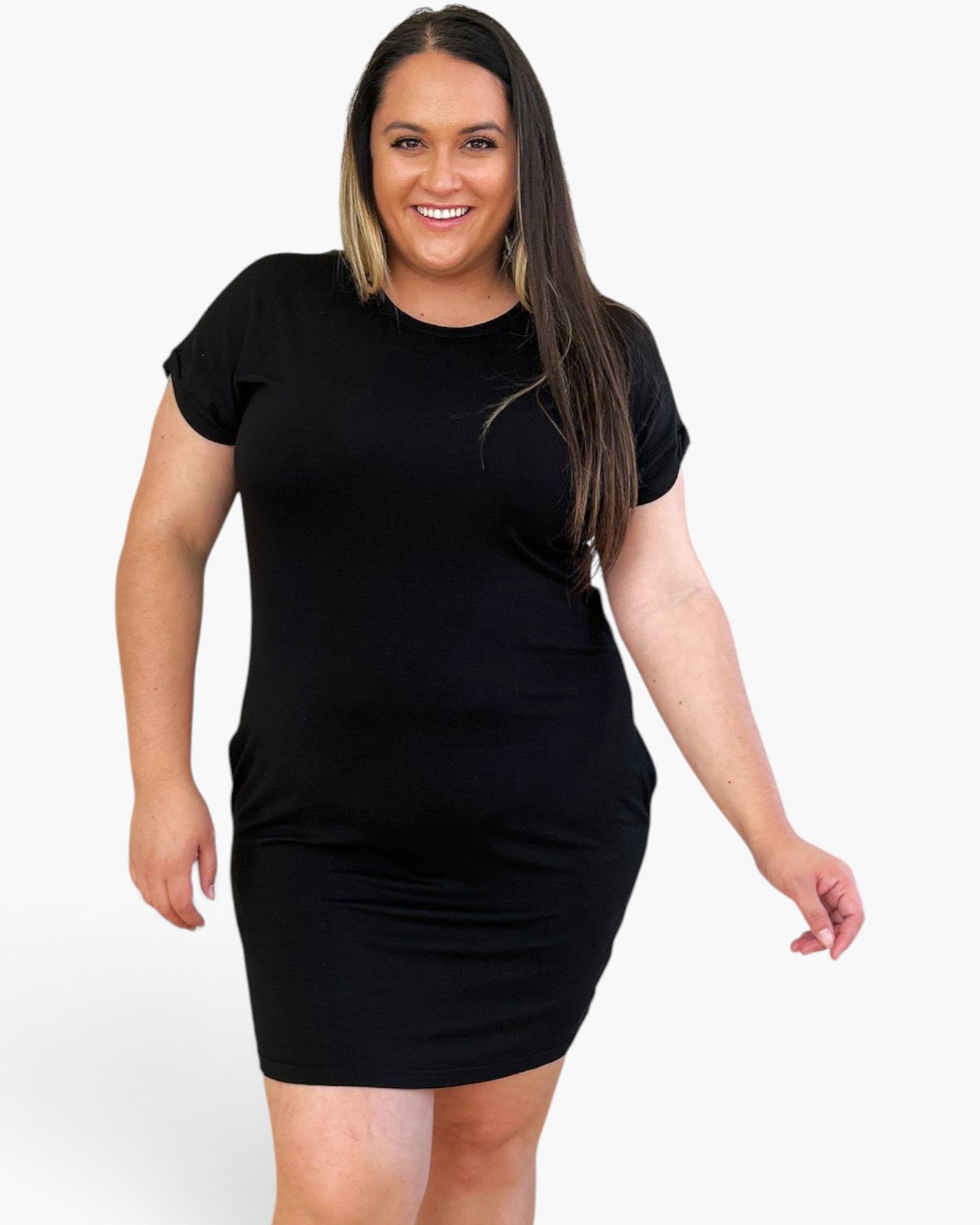 A woman modeling a black short-sleeve bodycon mini dress against a plain light gray studio background.