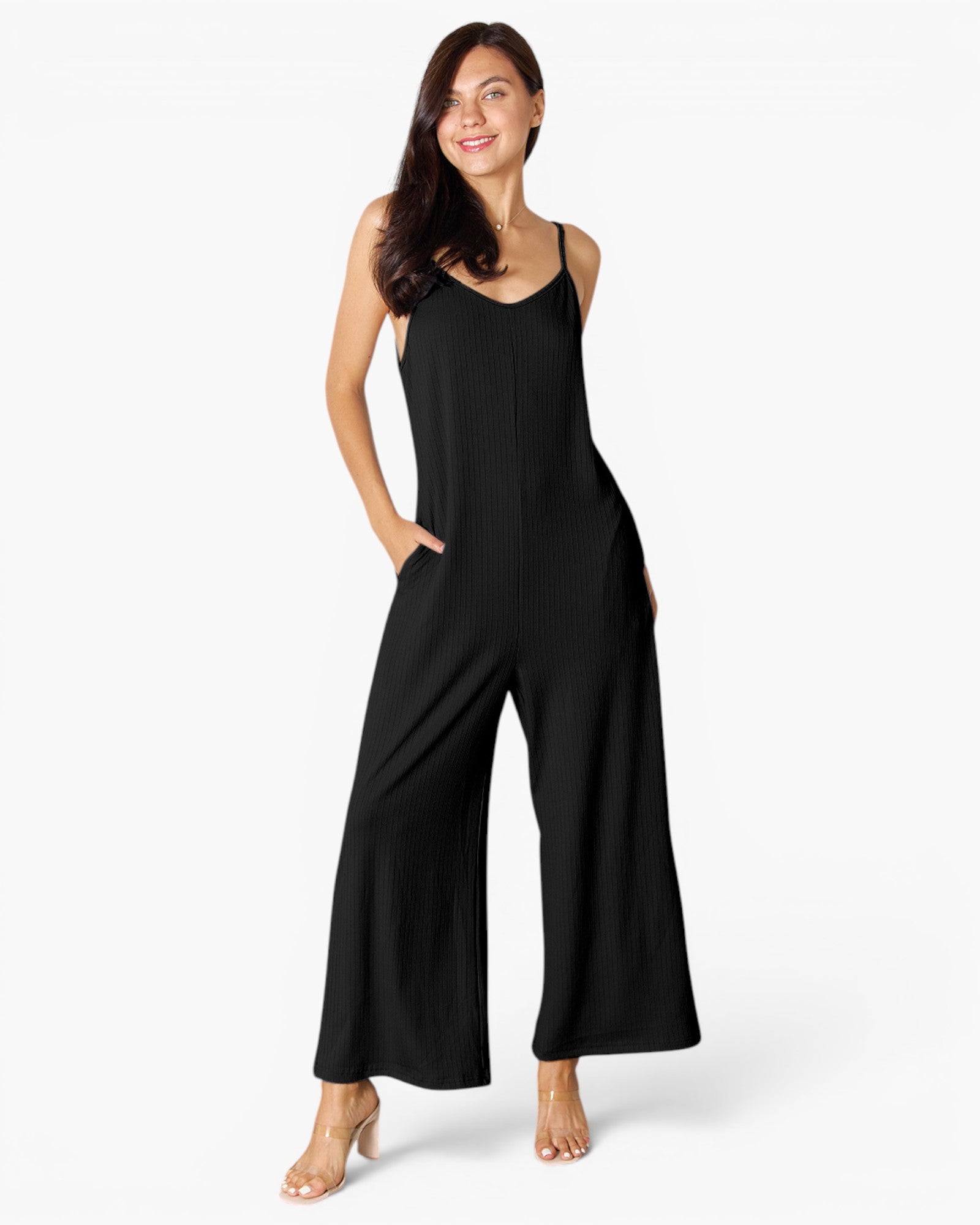 A woman modeling a black sleeveless wide-leg jumpsuit against a clean white studio background.