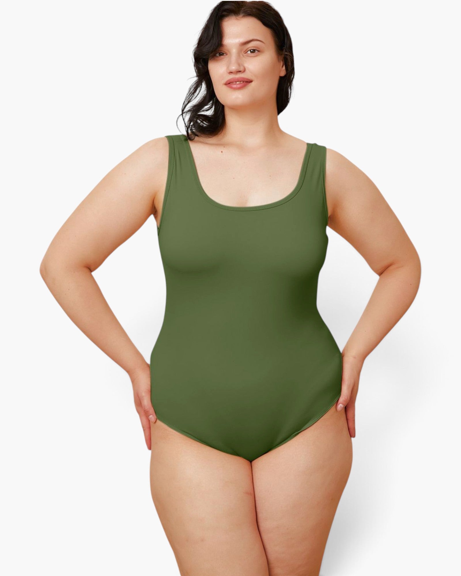 A woman modeling a sleeveless one-piece swimsuit in olive green against a plain light gray studio background.