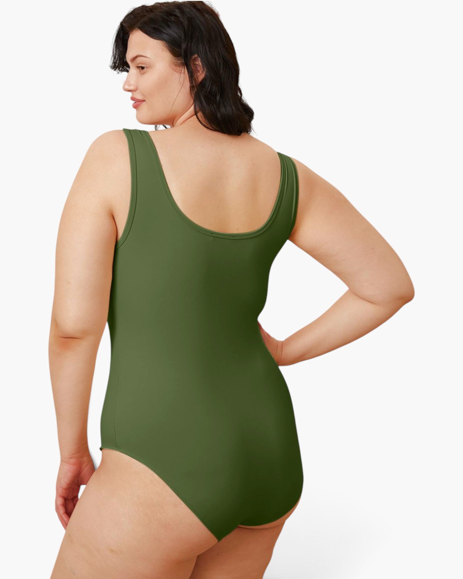 A woman wearing an olive green one-piece swimsuit, shown from a back three-quarter angle against a plain white studio background.