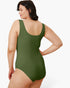 A woman wearing an olive green one-piece swimsuit, shown from a back three-quarter angle against a plain white studio background.