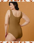 Woman wearing a brown swimsuit against an orange background