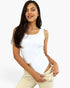 A woman modeling a white sleeveless scoop-neck bodysuit paired with light beige jeans against a plain white background.