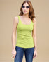 Woman wearing a green tank top and sunglasses against a beige background
