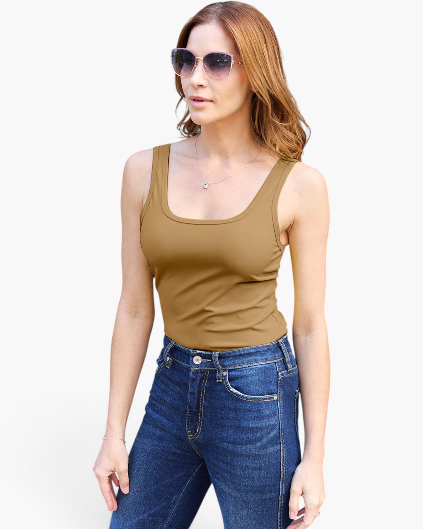 A woman modeling a fitted scoop-neck tank top in a warm tan or camel shade, paired with blue jeans and sunglasses, against a plain white studio background.