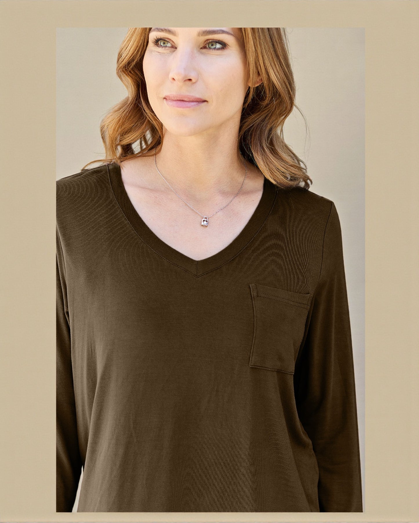 Woman wearing a brown long-sleeve top with a pocket on a beige background