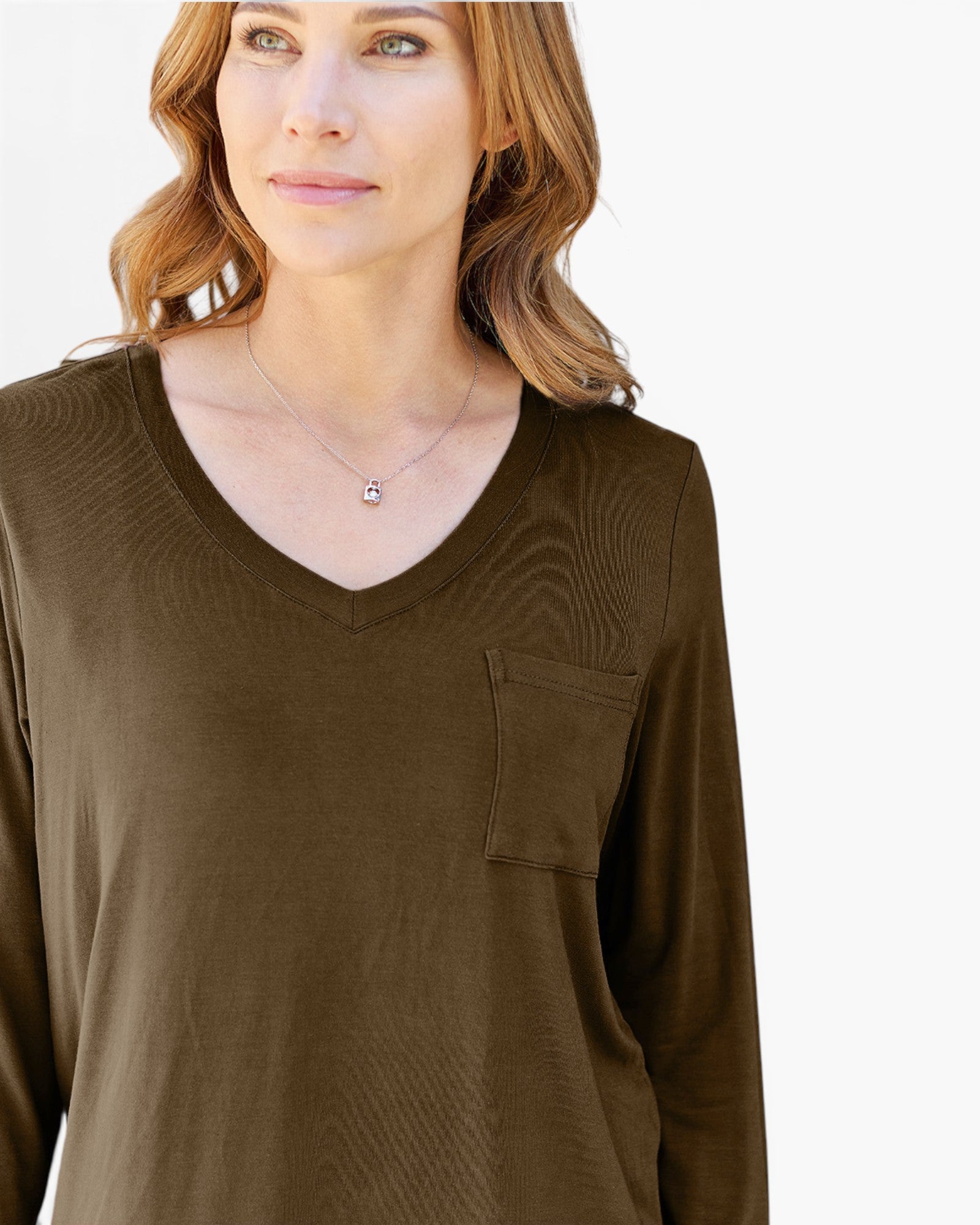 A woman wearing a long-sleeve V-neck top in olive brown with a chest pocket, shown against a plain light background.