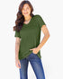 A woman wearing an olive green short-sleeve V-neck top with a chest pocket, paired with blue jeans, against a plain white background.