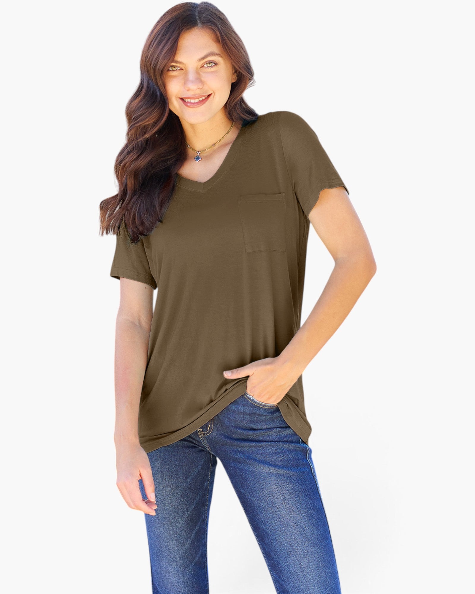 A woman modeling a short-sleeve V-neck top in olive green, paired with blue jeans, against a plain white background.