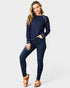 Woman wearing a navy blue sweater and jeans on a white background