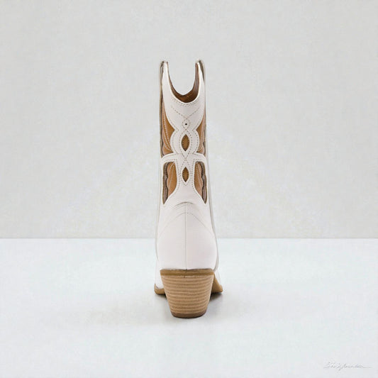 White cowboy boot with brown accents on a white background