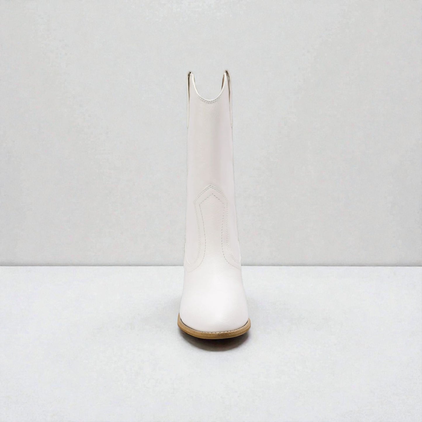 White knee-high boot on a white background