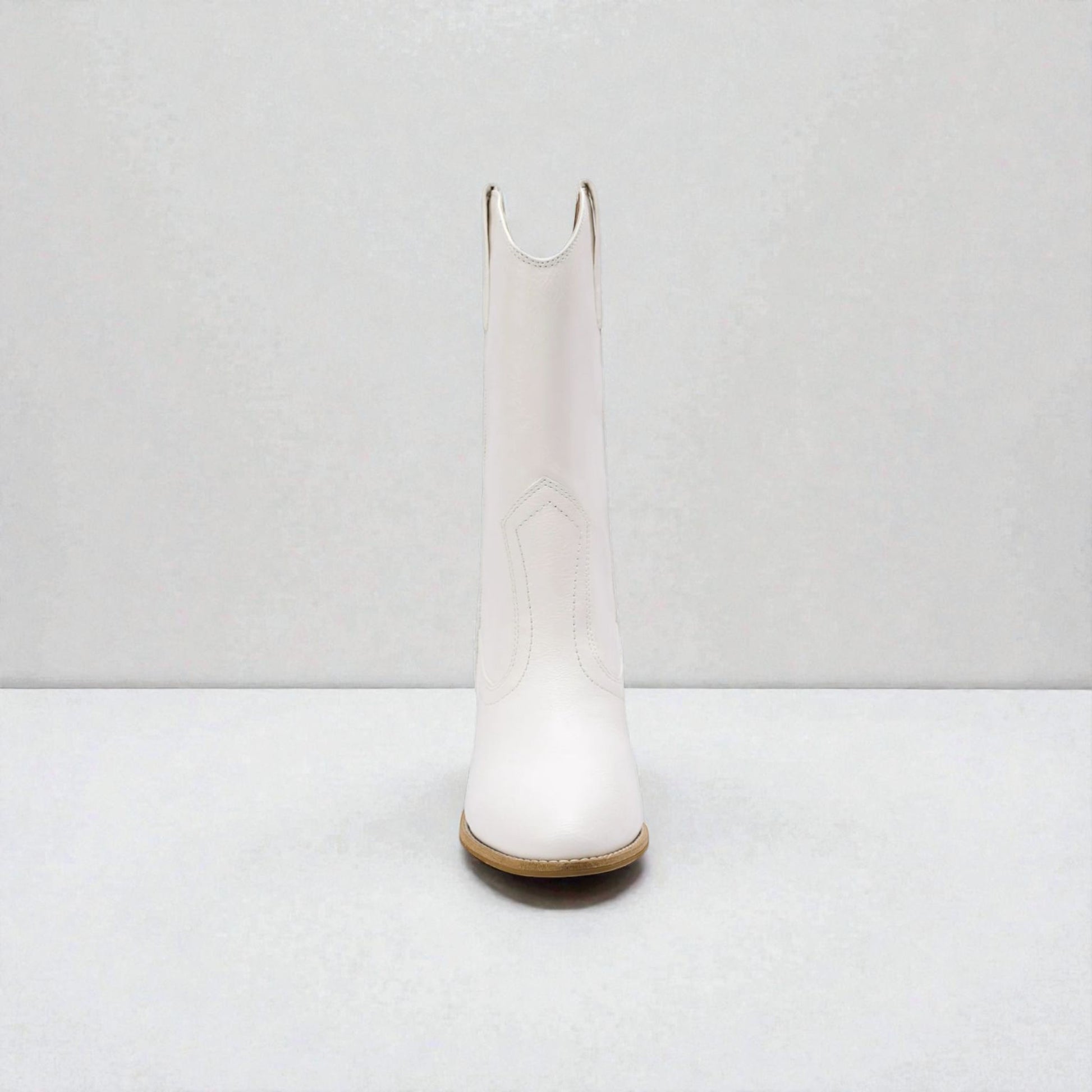 White knee-high boot on a white background