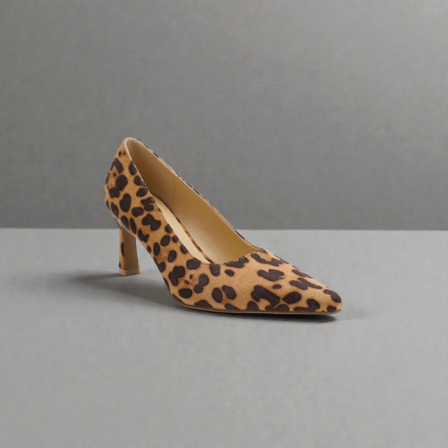 Leopard print high heel shoe on a gray background