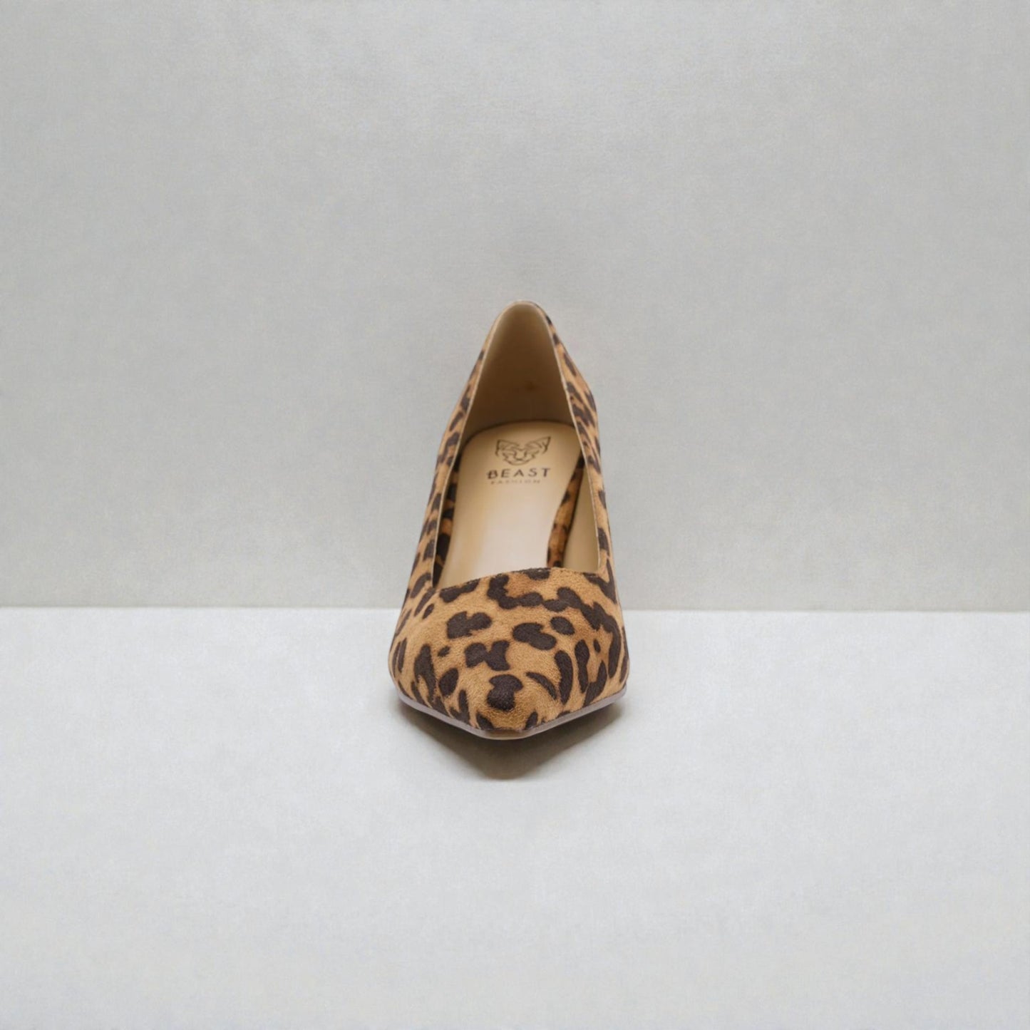 Leopard print high heel shoe on a white background