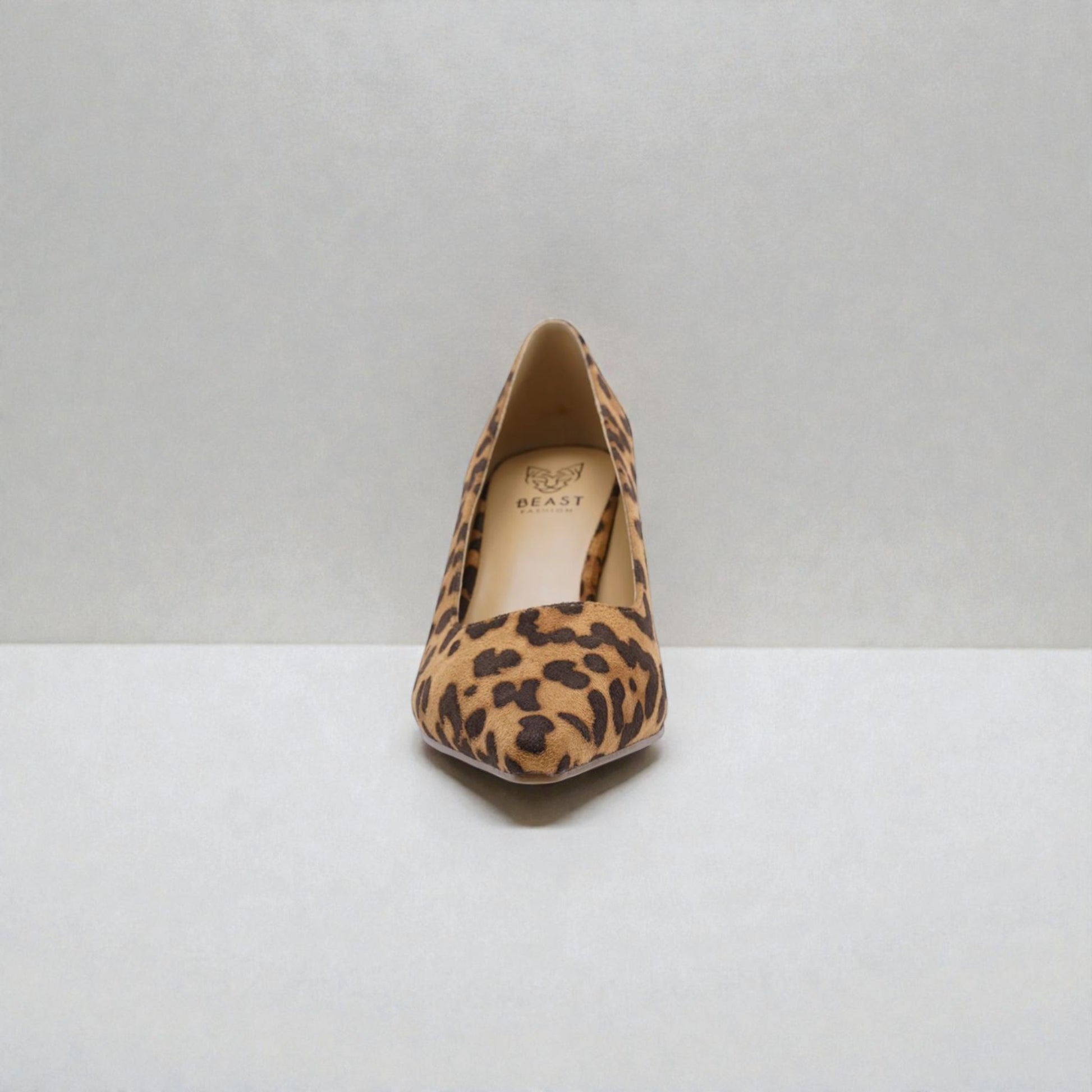 Leopard print high heel shoe on a white background