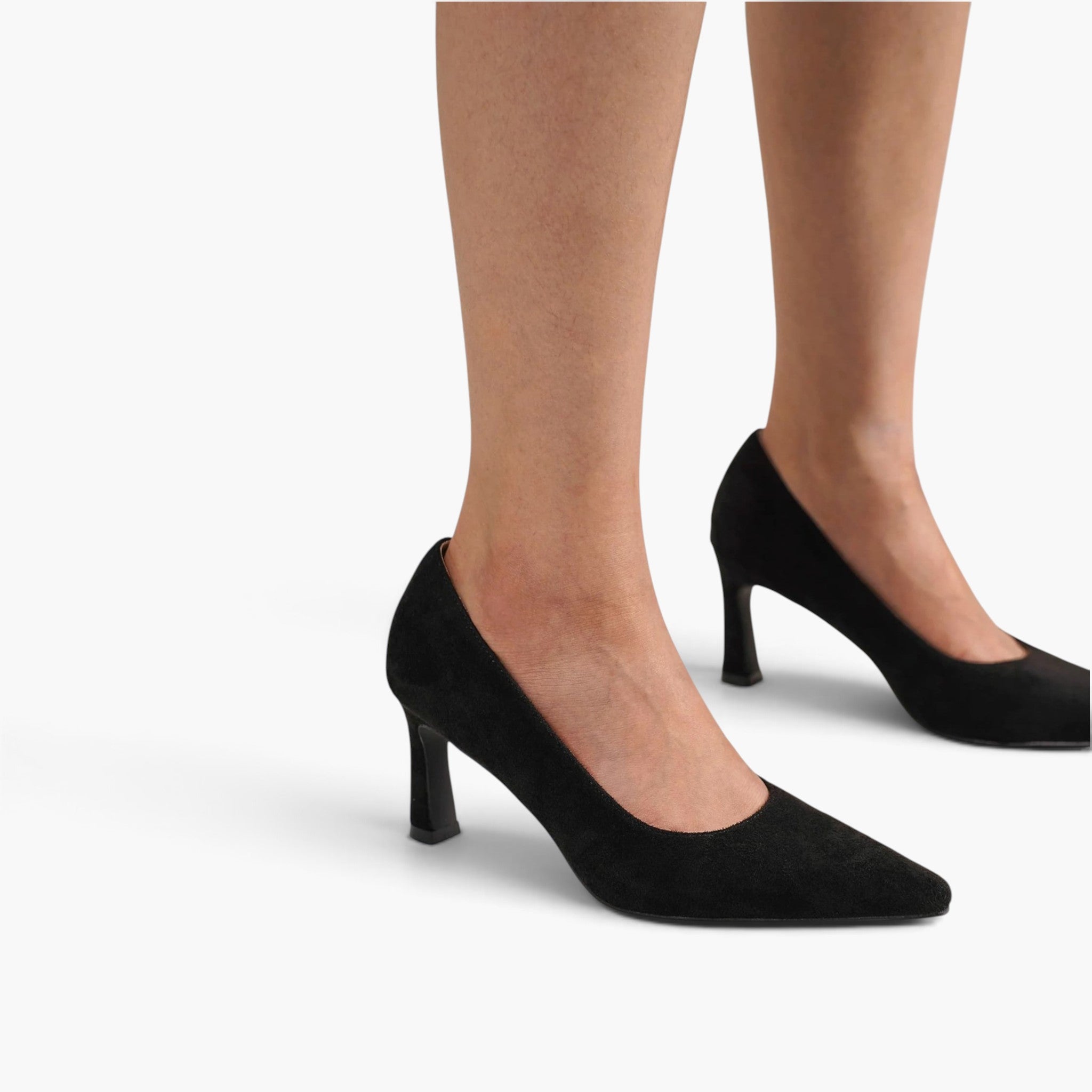 Black pointed-toe high heels with a kitten heel, shown on a model's feet against a clean white background.