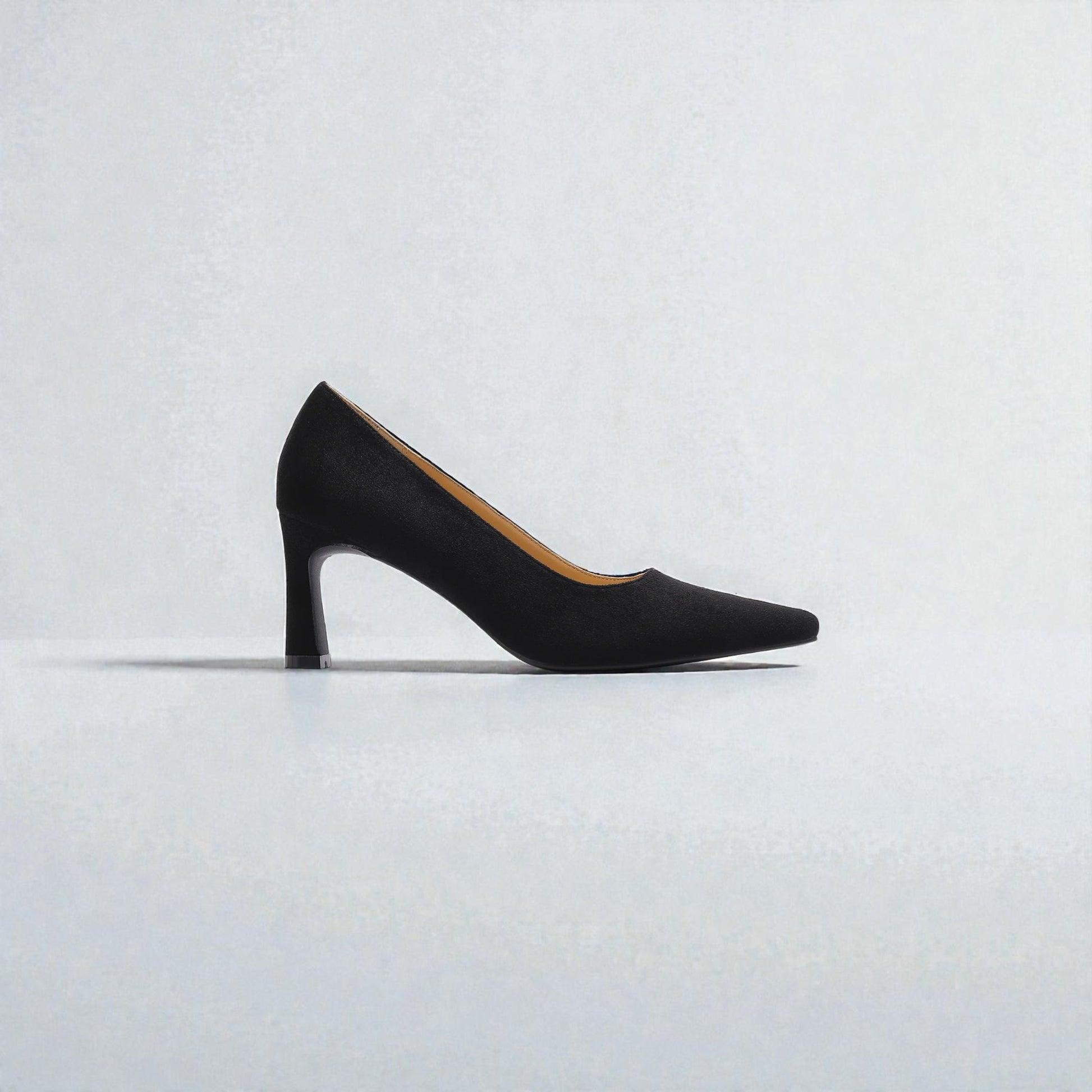 Black high-heeled shoe on a light gray background