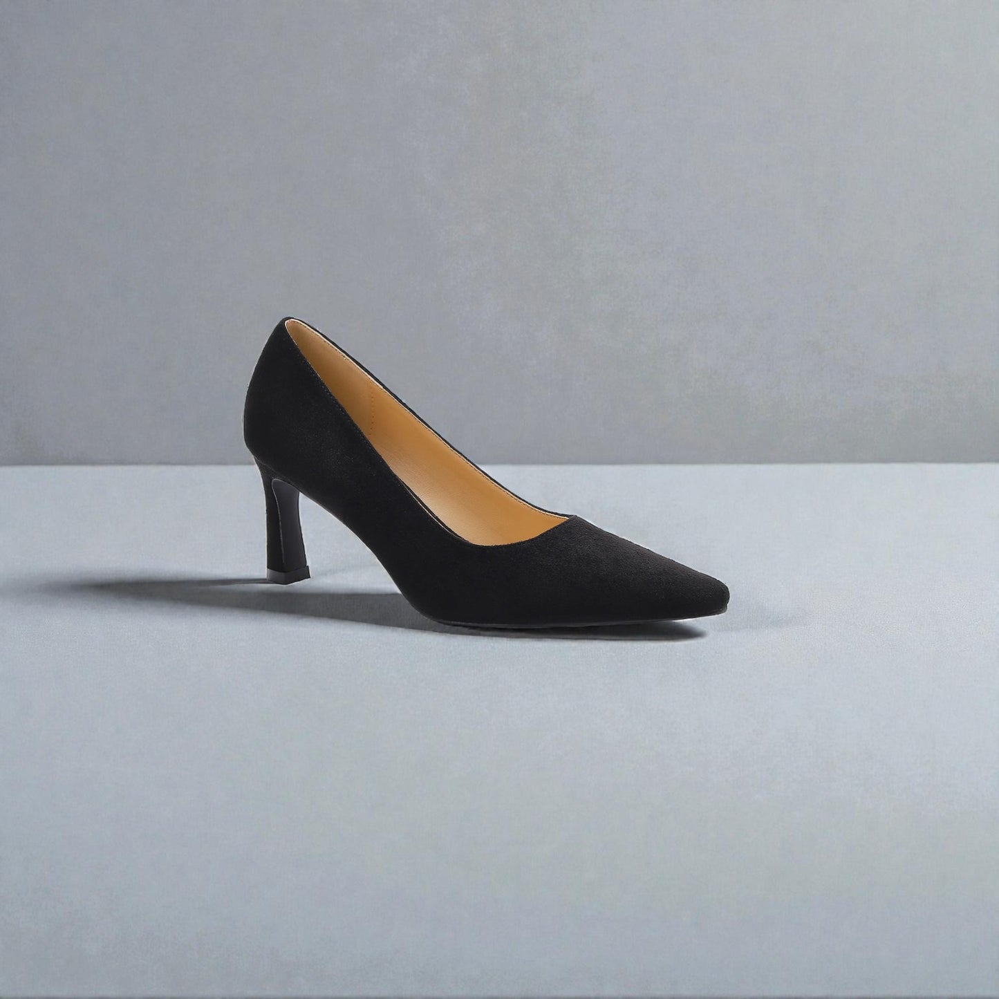 Black high-heeled shoe on a gray background