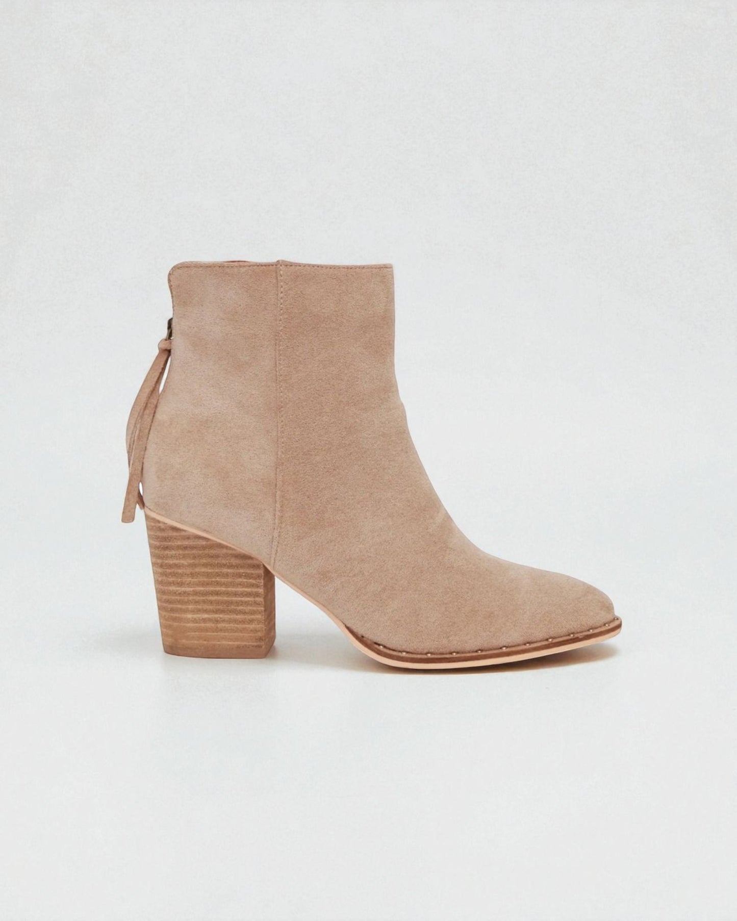 Beige ankle boot with a block heel on a white background