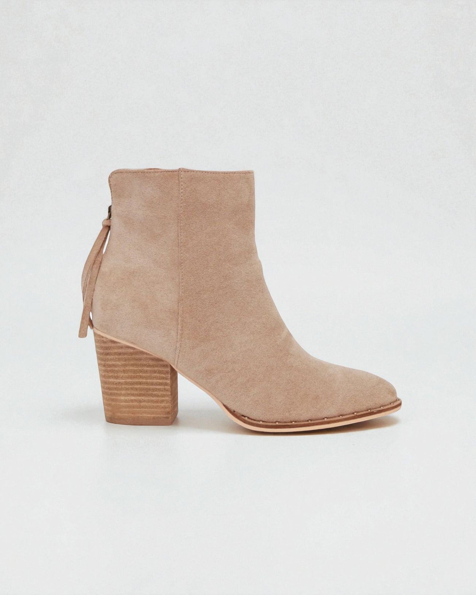 Beige ankle boot with a block heel on a white background