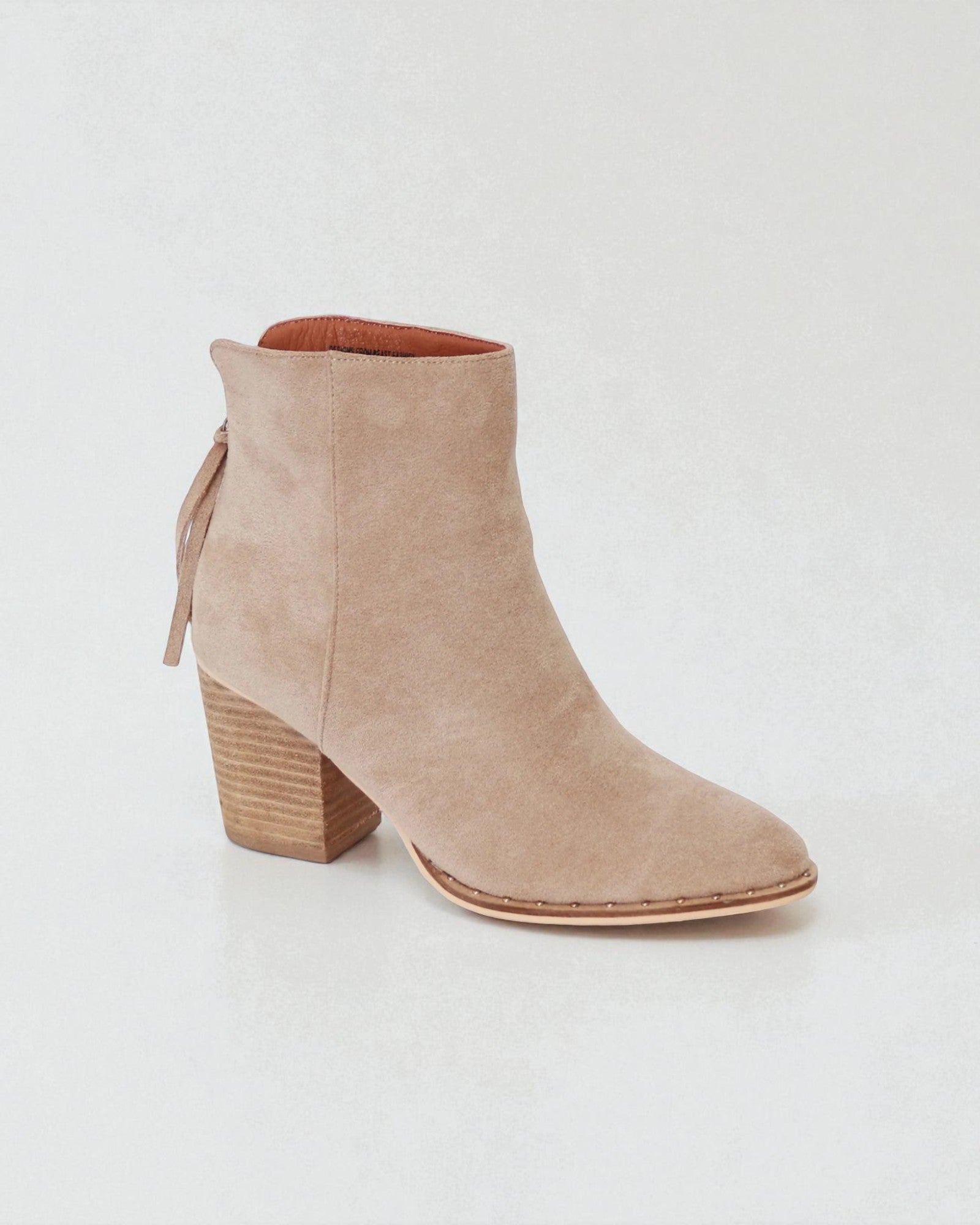 Beige ankle boot with a block heel on a white background