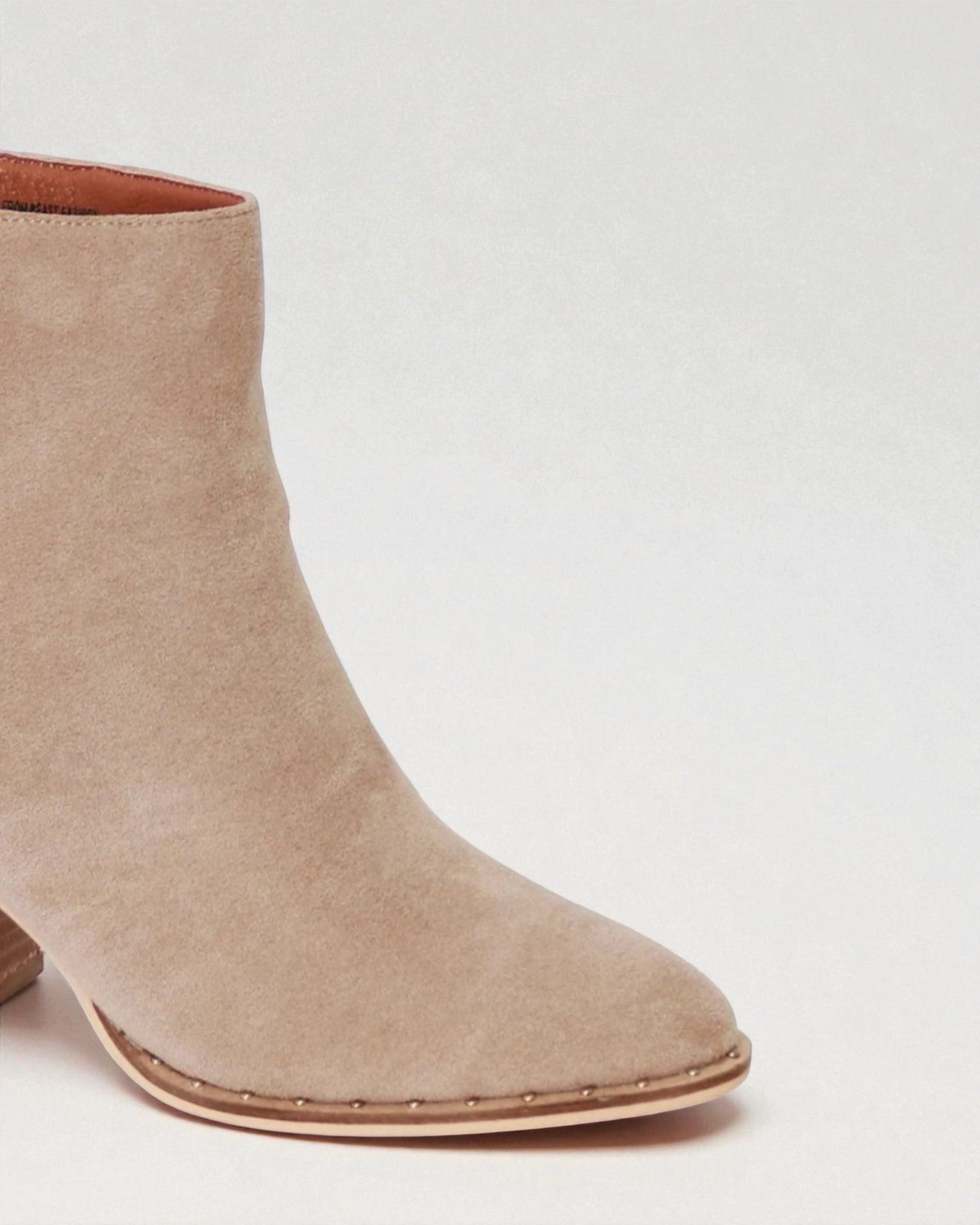 Beige ankle boot on a light gray background