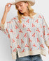 Woman wearing a striped sweater with red lobster pattern on a plain background