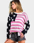 Woman wearing a colorful sweater with American flag design on a plain background
