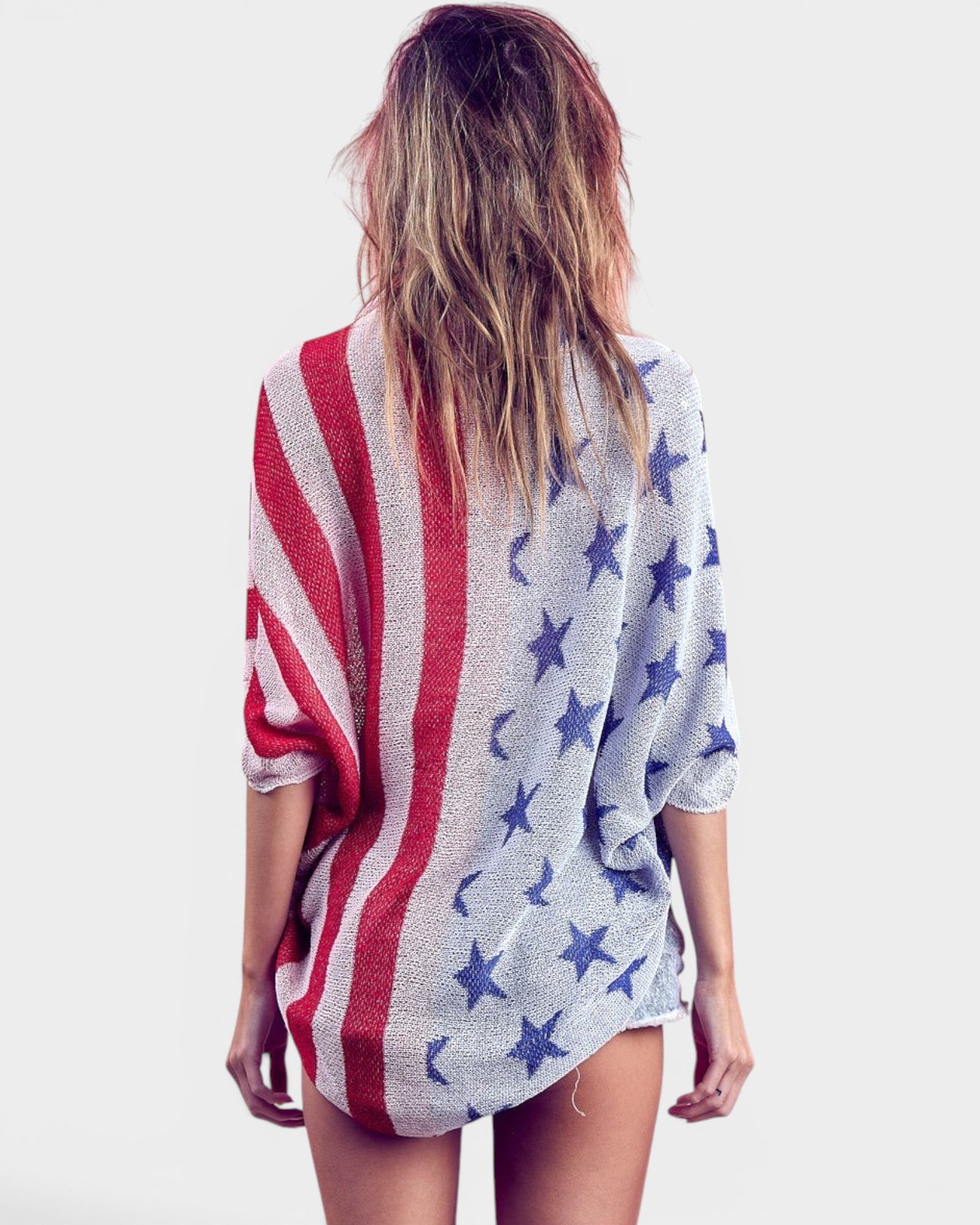 Person wearing a cardigan with an American flag pattern on a white background