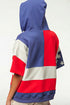 Person wearing a hoodie with a colorful pattern on a white background