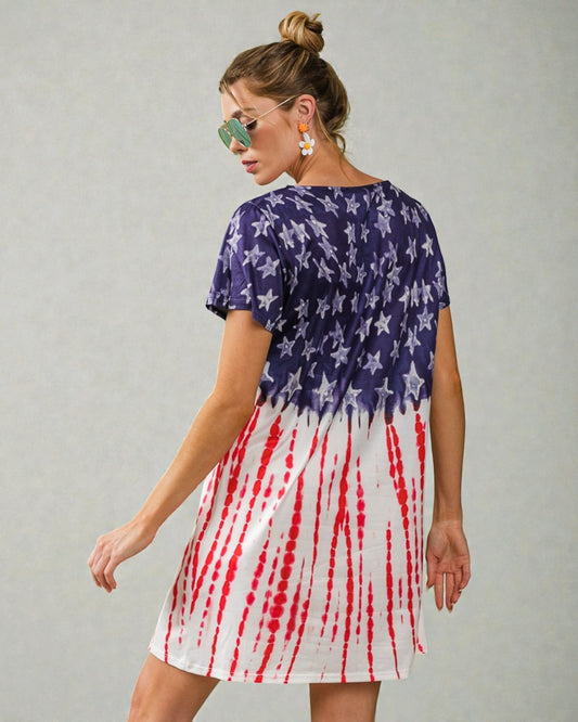 Woman wearing a dress with American flag design on a plain background