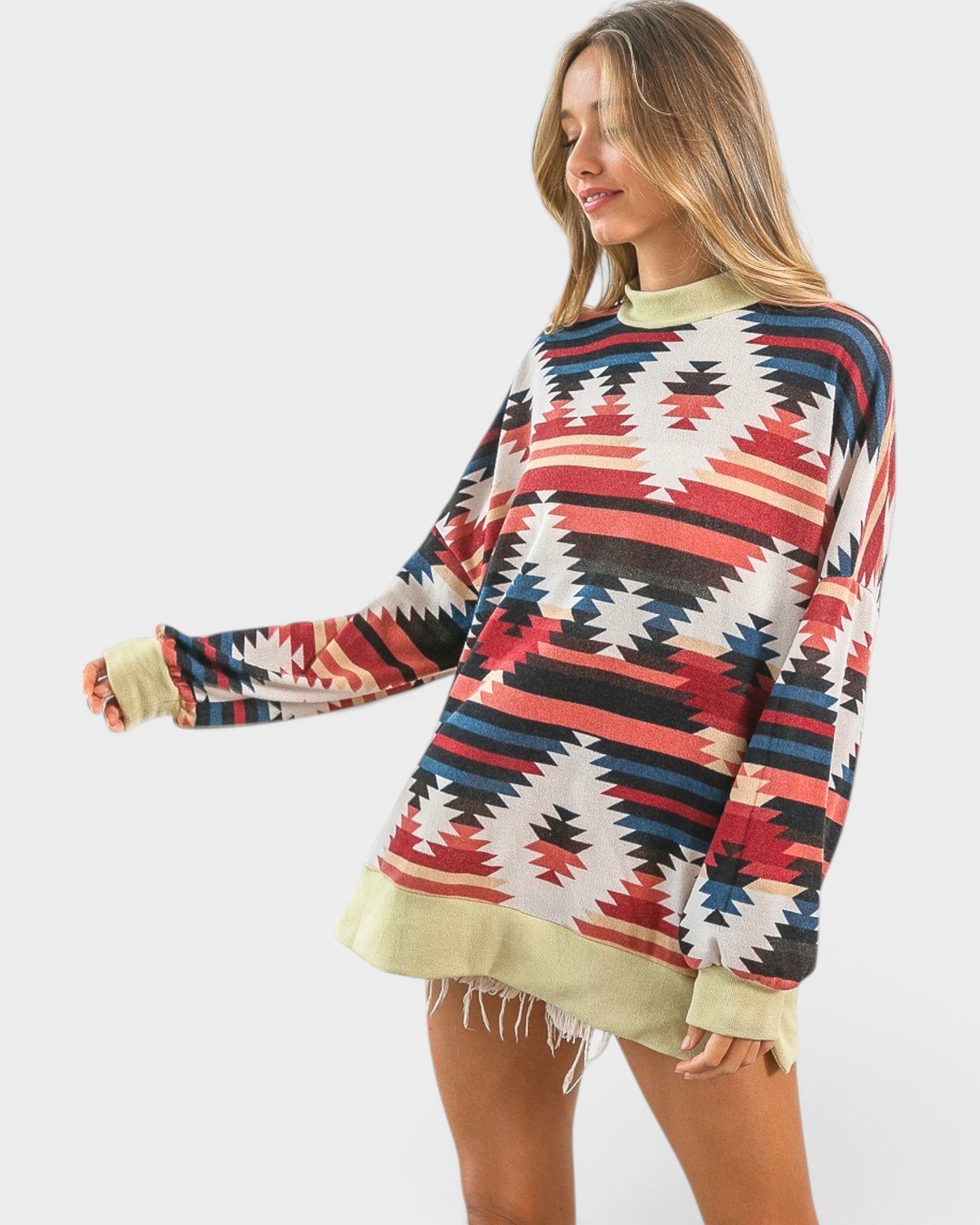 Woman wearing a colorful patterned sweater on a white background