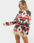 Woman wearing a colorful patterned sweater on a white background