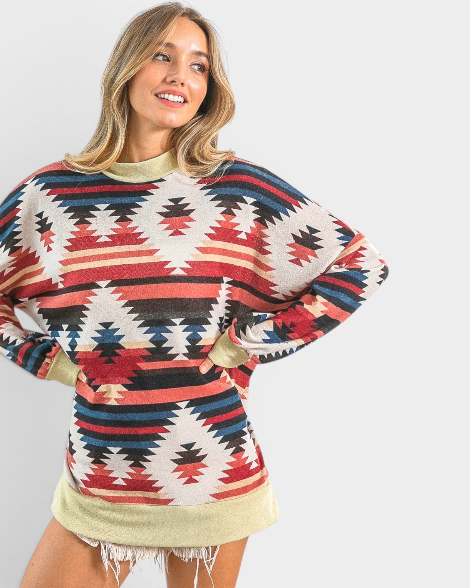 Woman wearing a patterned sweater with a plain background