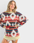 Woman wearing a patterned sweater with a plain background
