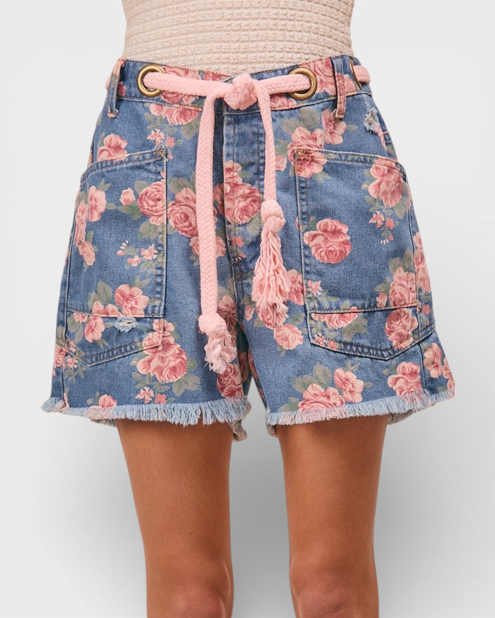 Floral denim shorts with a pink drawstring on a white background