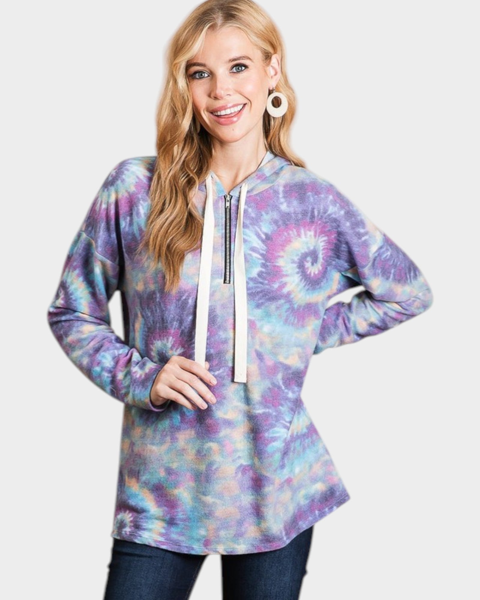 Woman wearing a tie-dye hoodie with a plain background