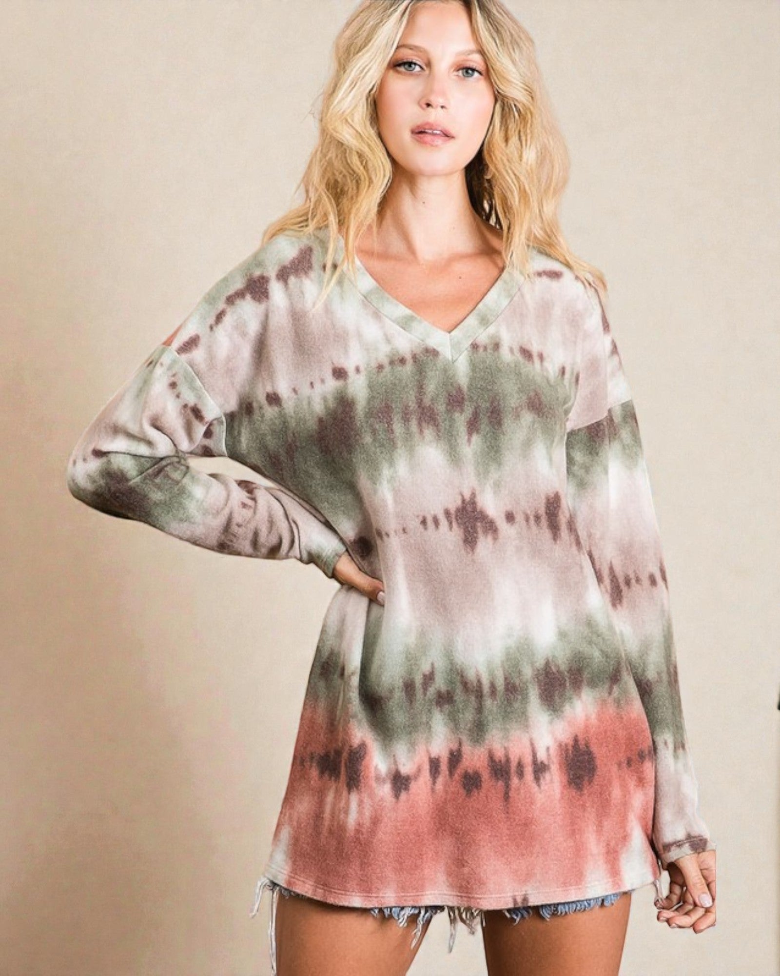 Woman wearing a tie-dye long-sleeve top against a beige background