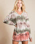 Woman wearing a tie-dye long-sleeve top against a beige background